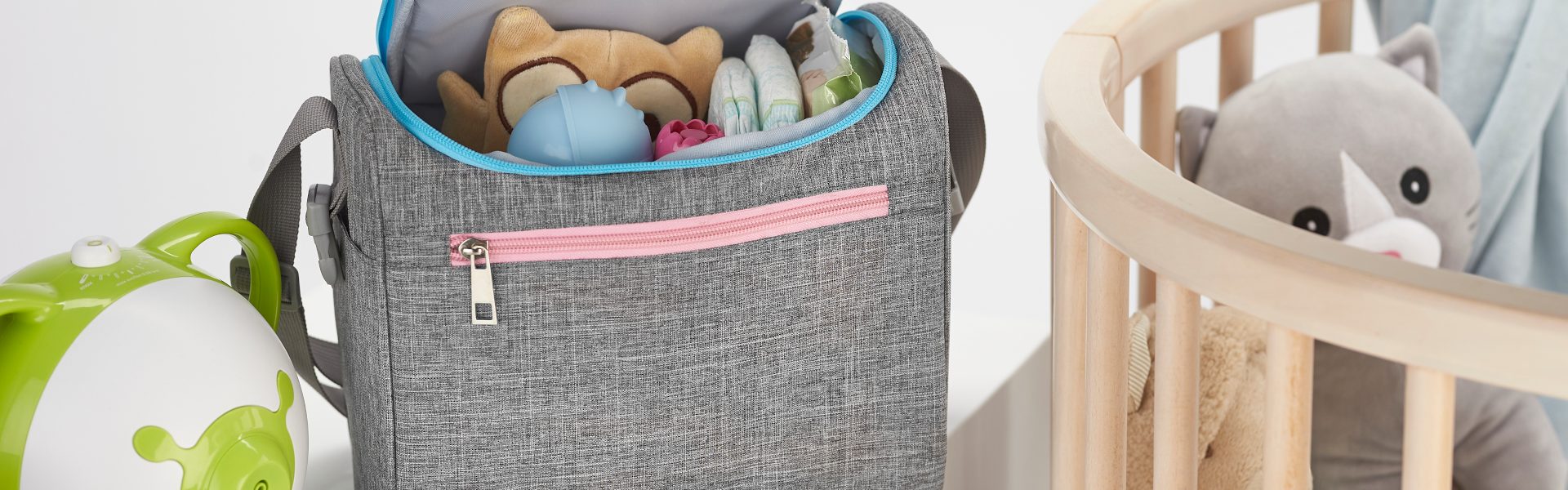 Nosiboo Bag Baby Organizer on a shelf next to the baby cot bed and filled with baby accessories